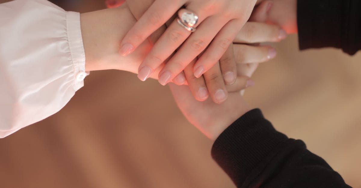 A close up of a person holding another person's hand.
