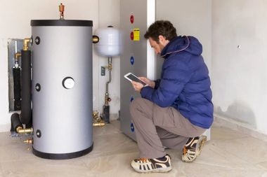 Man Checking Heating System — Groveland, MA — Mark Jr Plumbing & Heating Inc