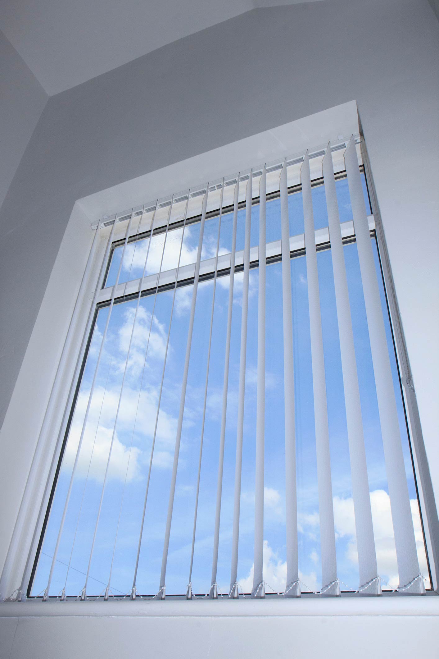 Vertical window blinds with blue sky background