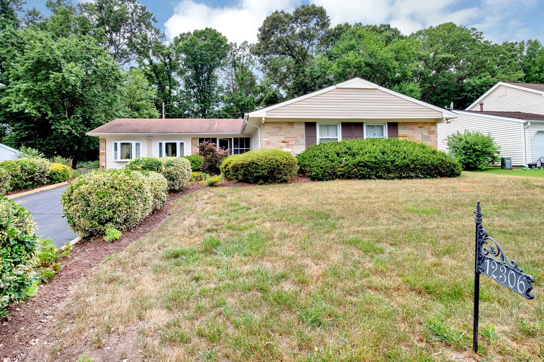 A house with a large lawn in front of it