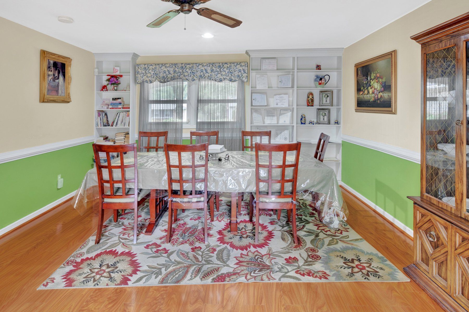 A dining room with a table and chairs and a rug