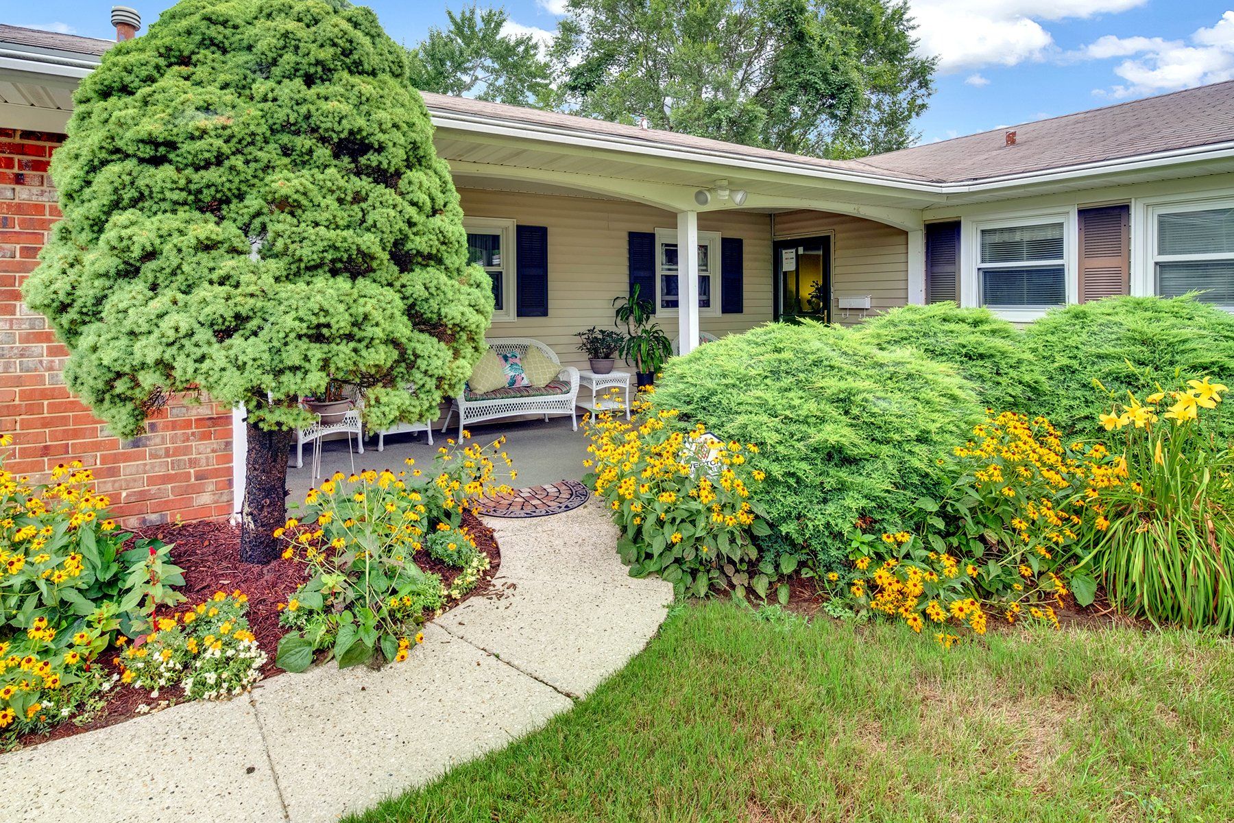 A house with a porch and a walkway leading to it