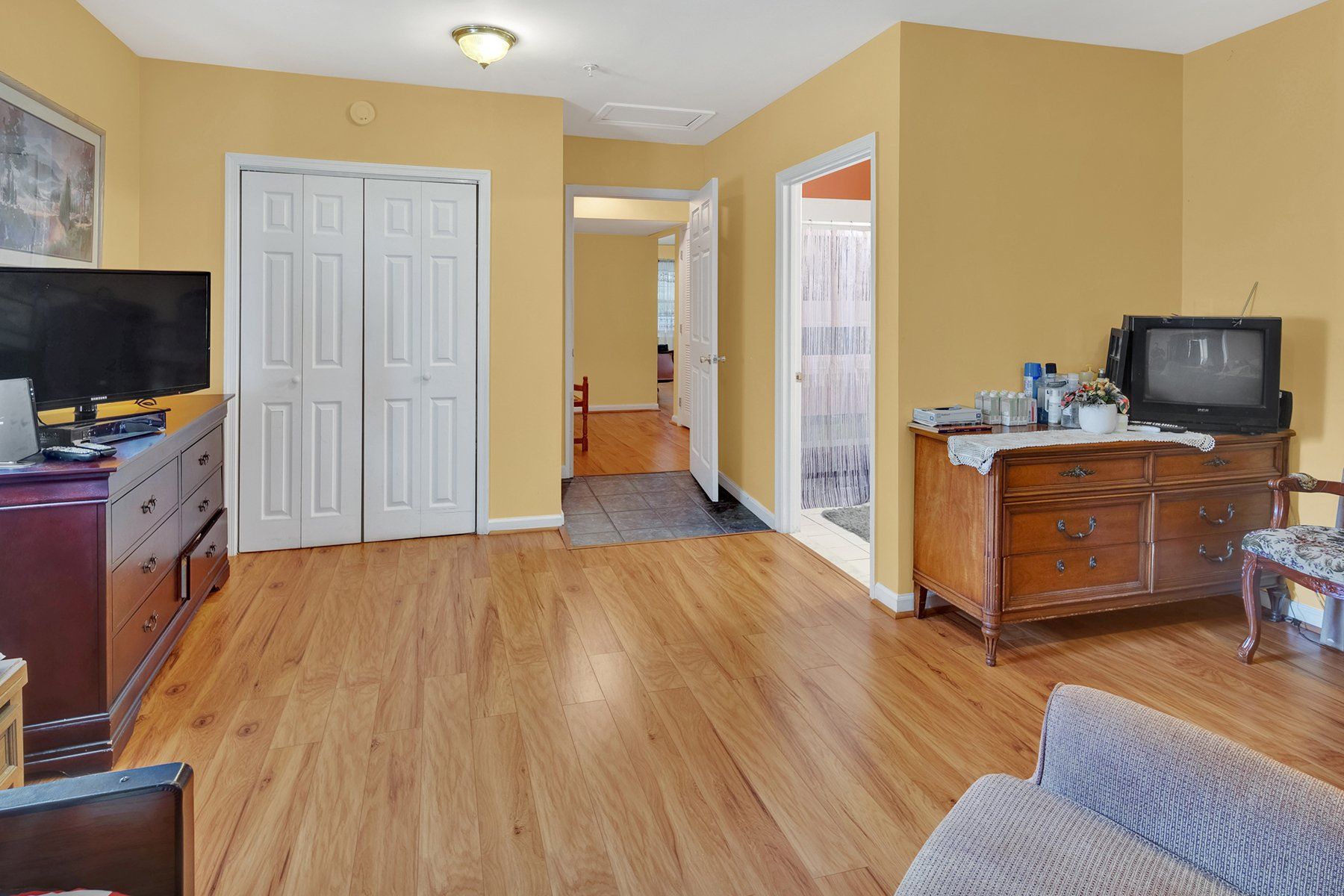 A living room with hardwood floors and a flat screen tv.