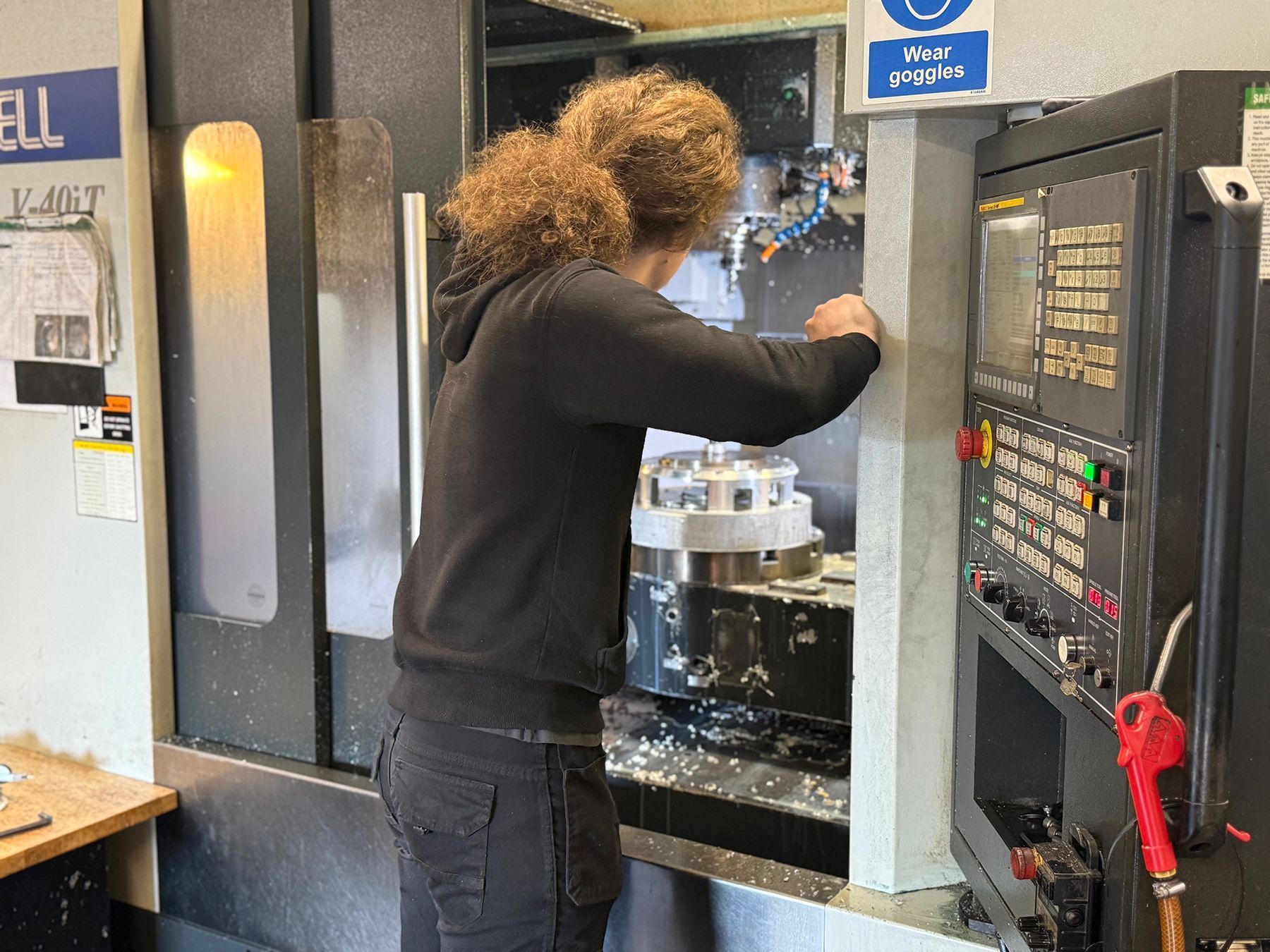 man working on cnc machine