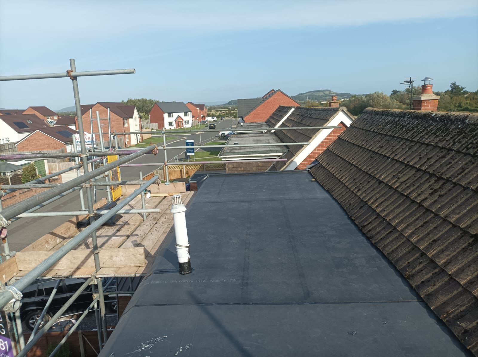 A roof with a black roof and scaffolding on it