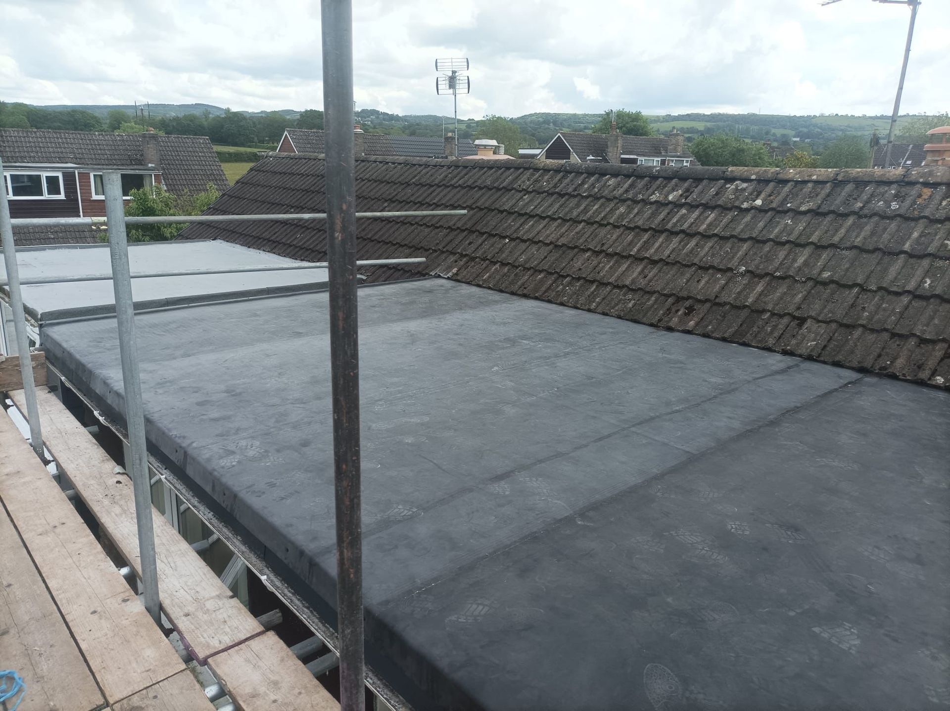 A roof with a black roof and a scaffolding on it.
