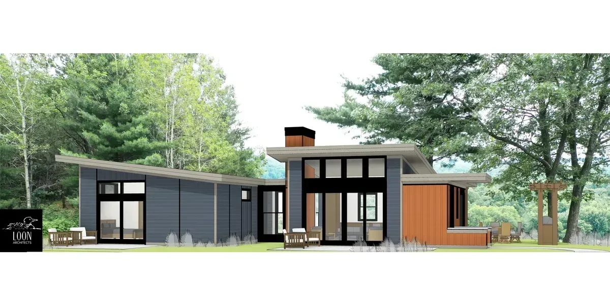 Modern home with a dark gray exterior, large windows, and a sloping roof, set in a wooded area.