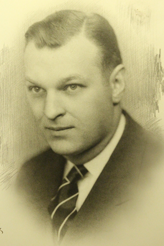 A black and white photo of a man in a suit and tie.