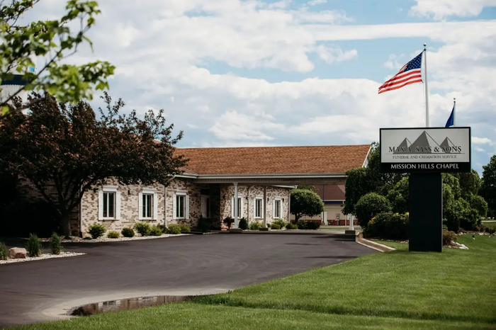 An american flag is flying in front of a building