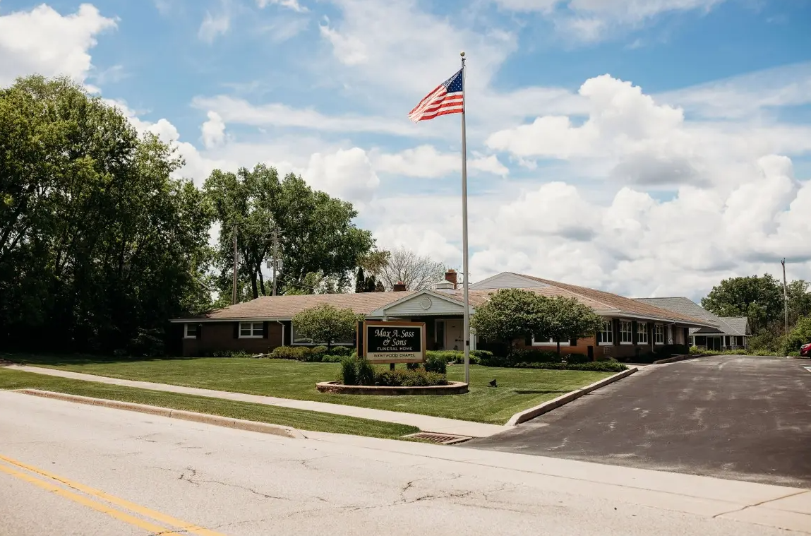 An american flag is flying in front of a house