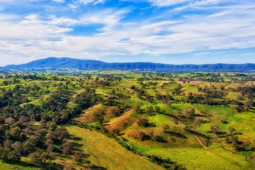 An Aerial View of a Lush Green Valley With Mountains — Queanbeyan Auto Parts in Bega, NSW