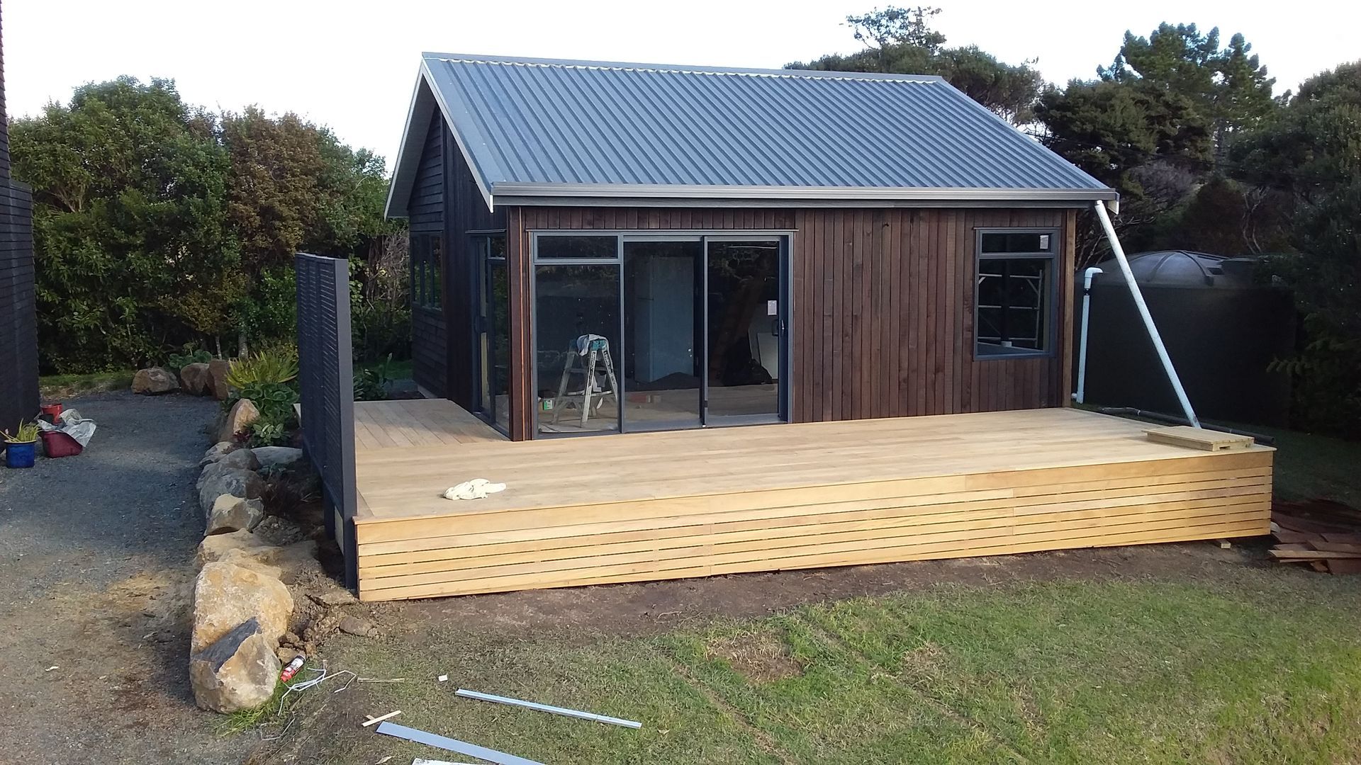 A small house with a wooden deck in front of it