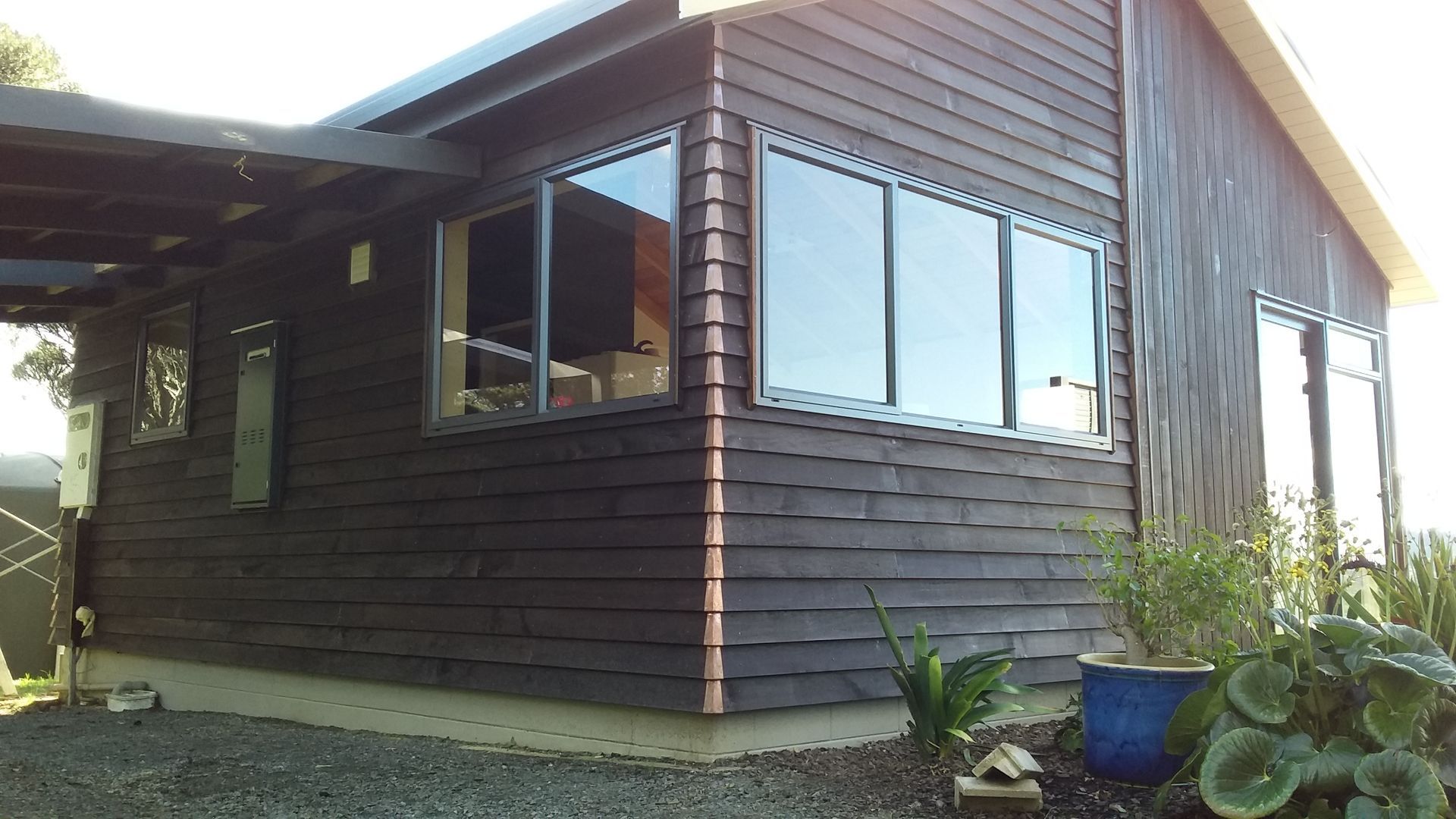 A house with a lot of windows and a carport