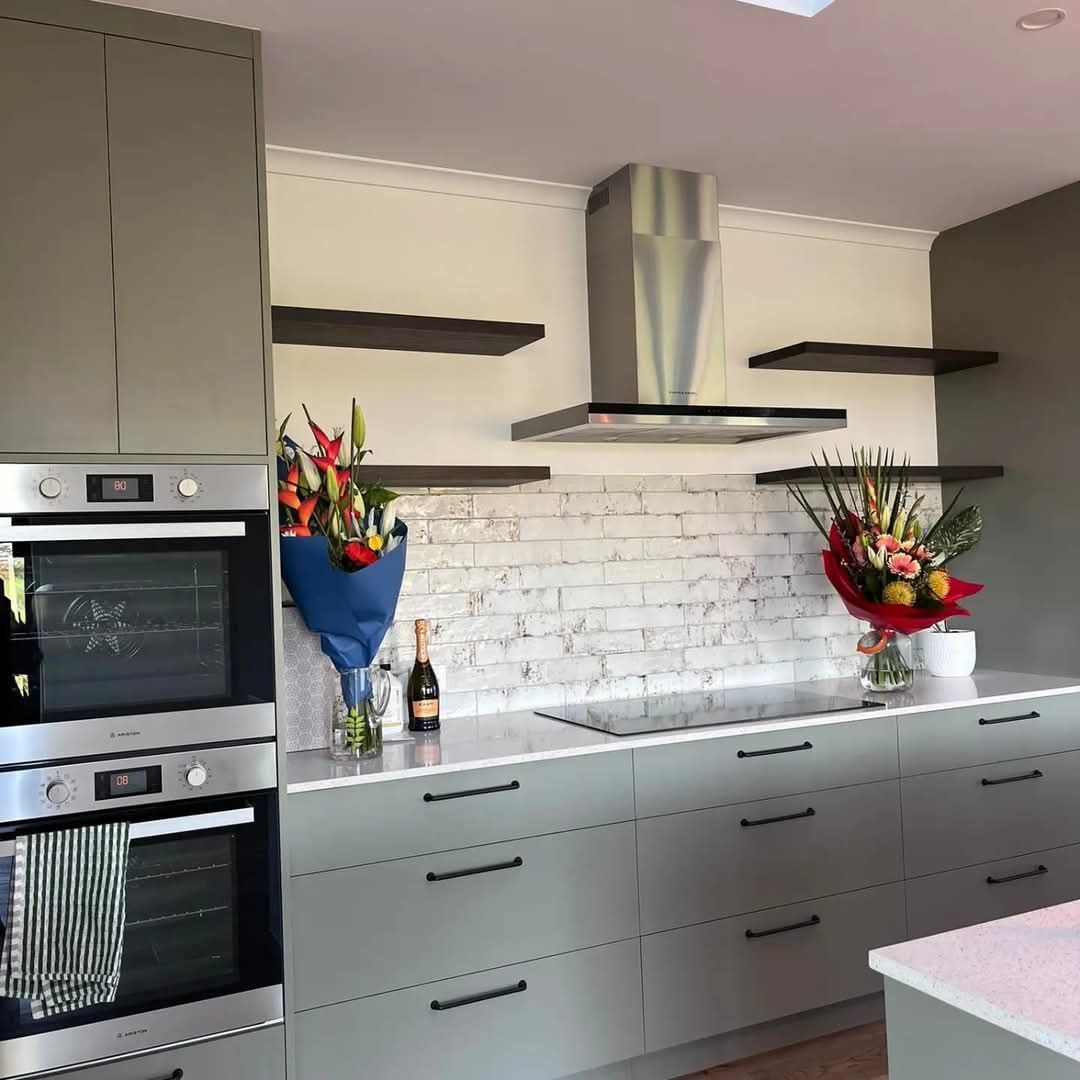 A kitchen with a bunch of flowers on the counter