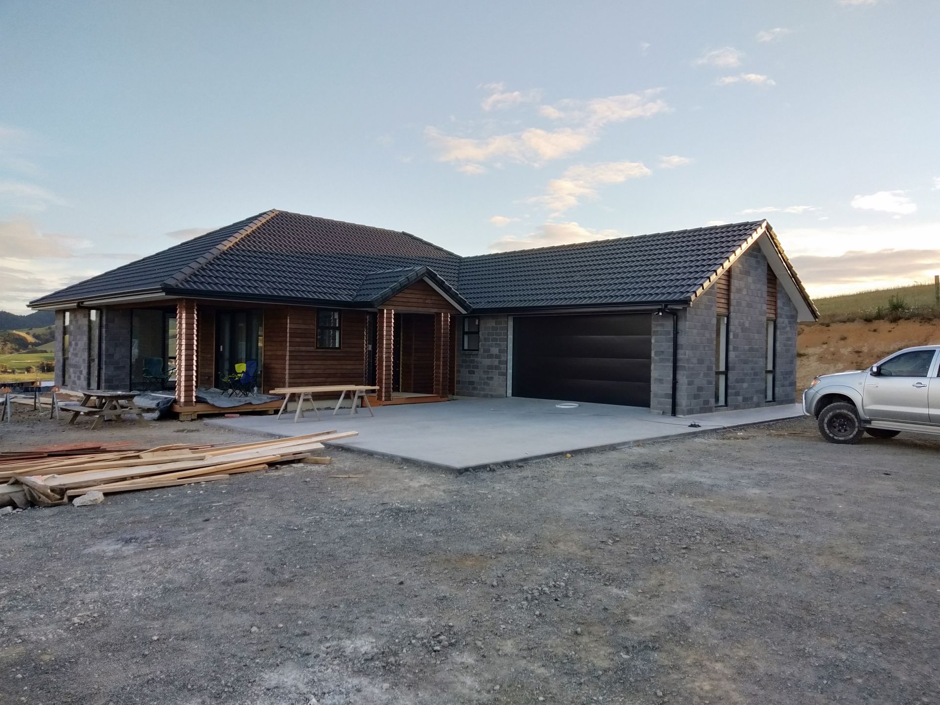 A white truck is parked in front of a house.