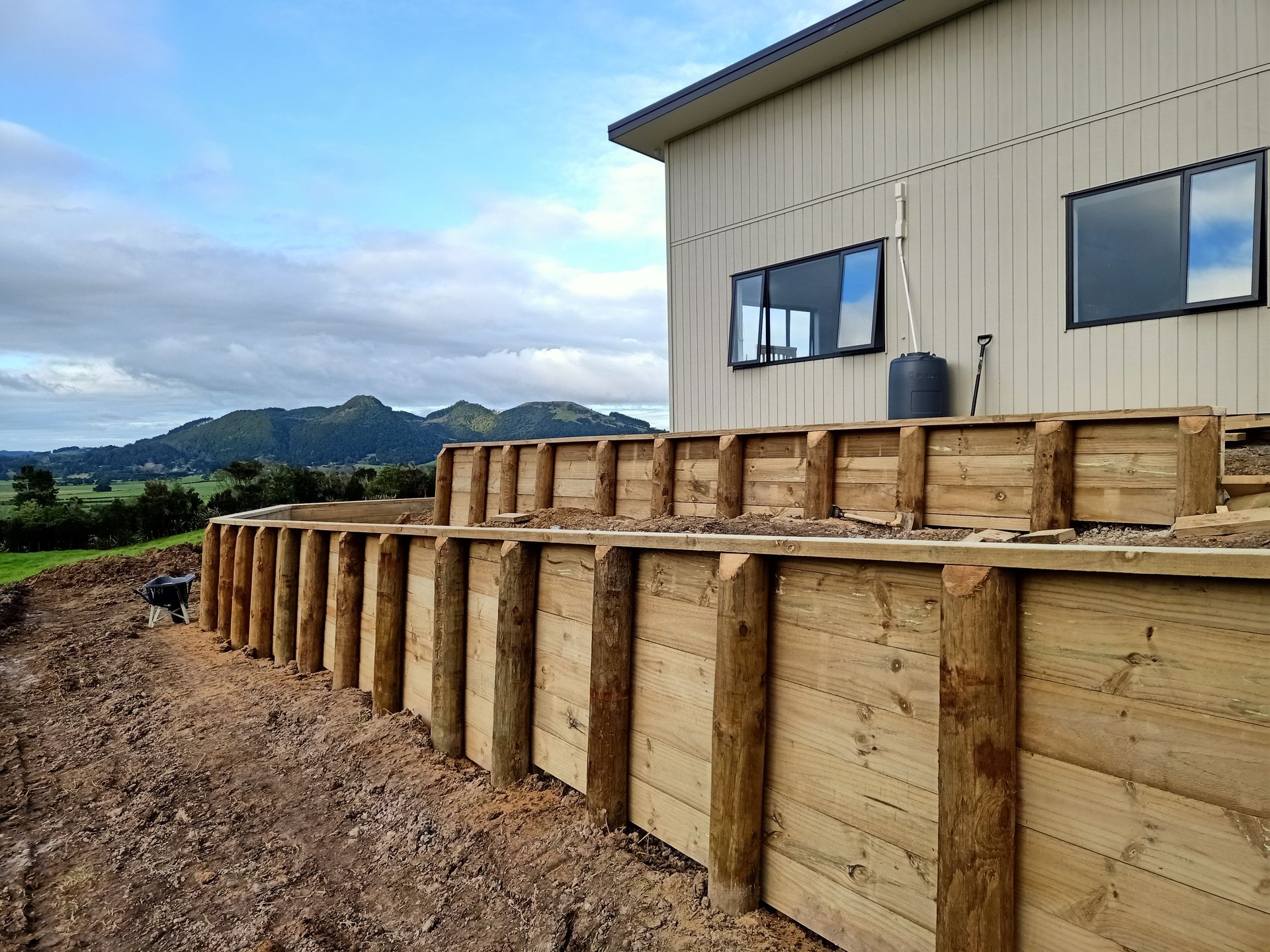 A wooden fence is being built in front of a house.