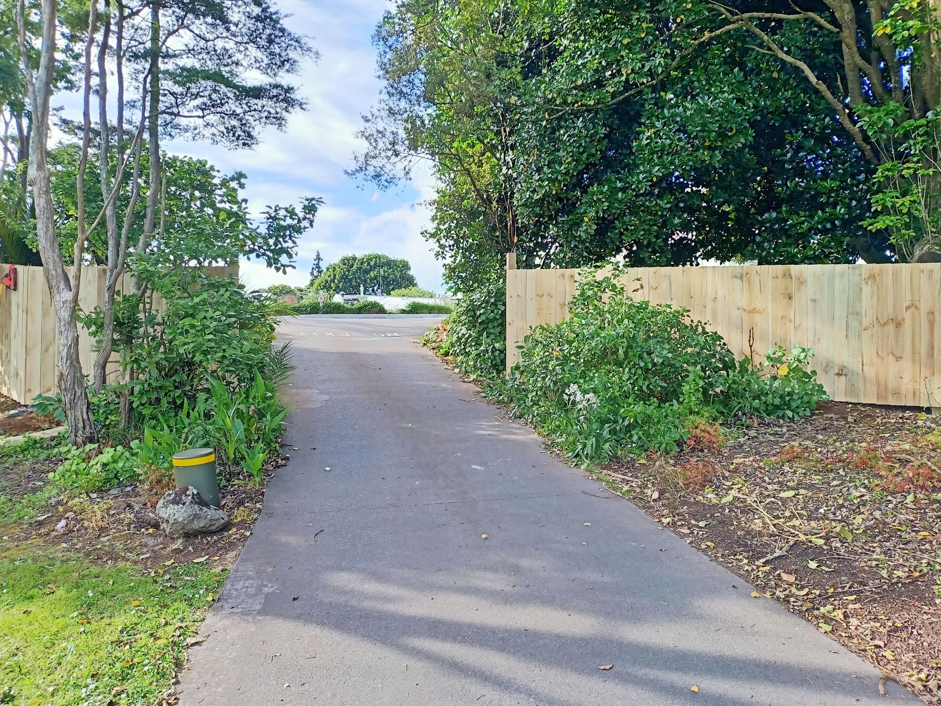 A road with a wooden fence on the side of it