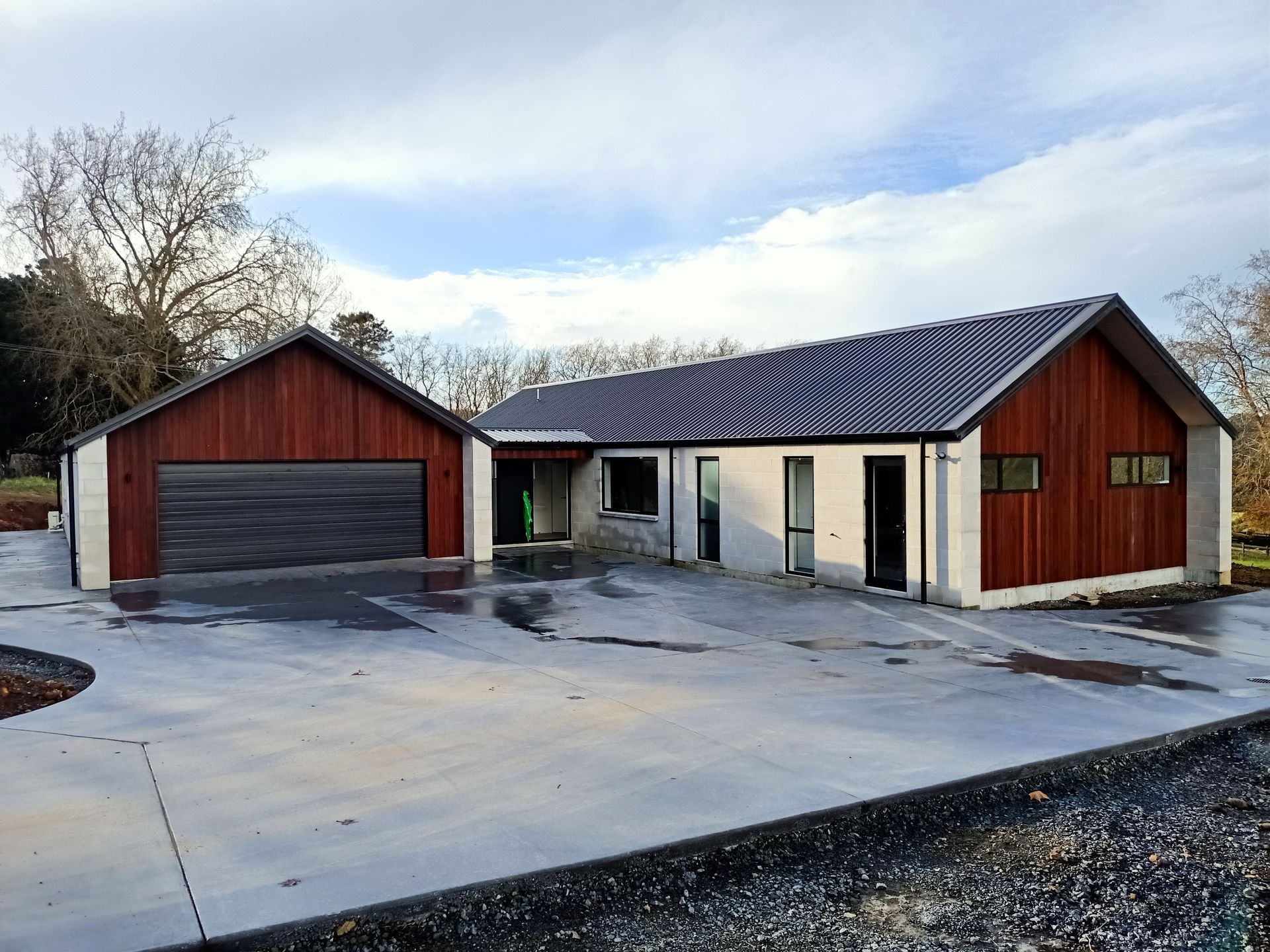 A large house with two garages and a driveway in front of it.