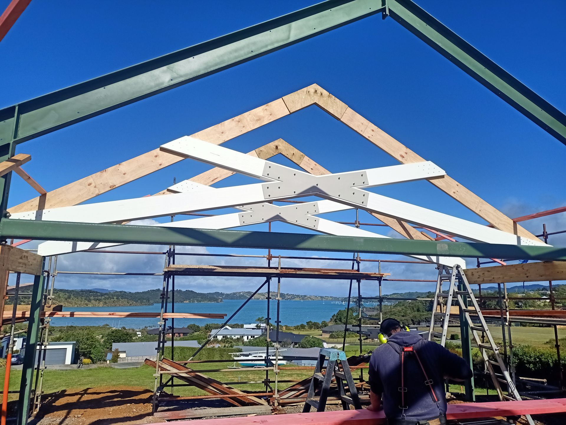 A man is standing in front of a building under construction.