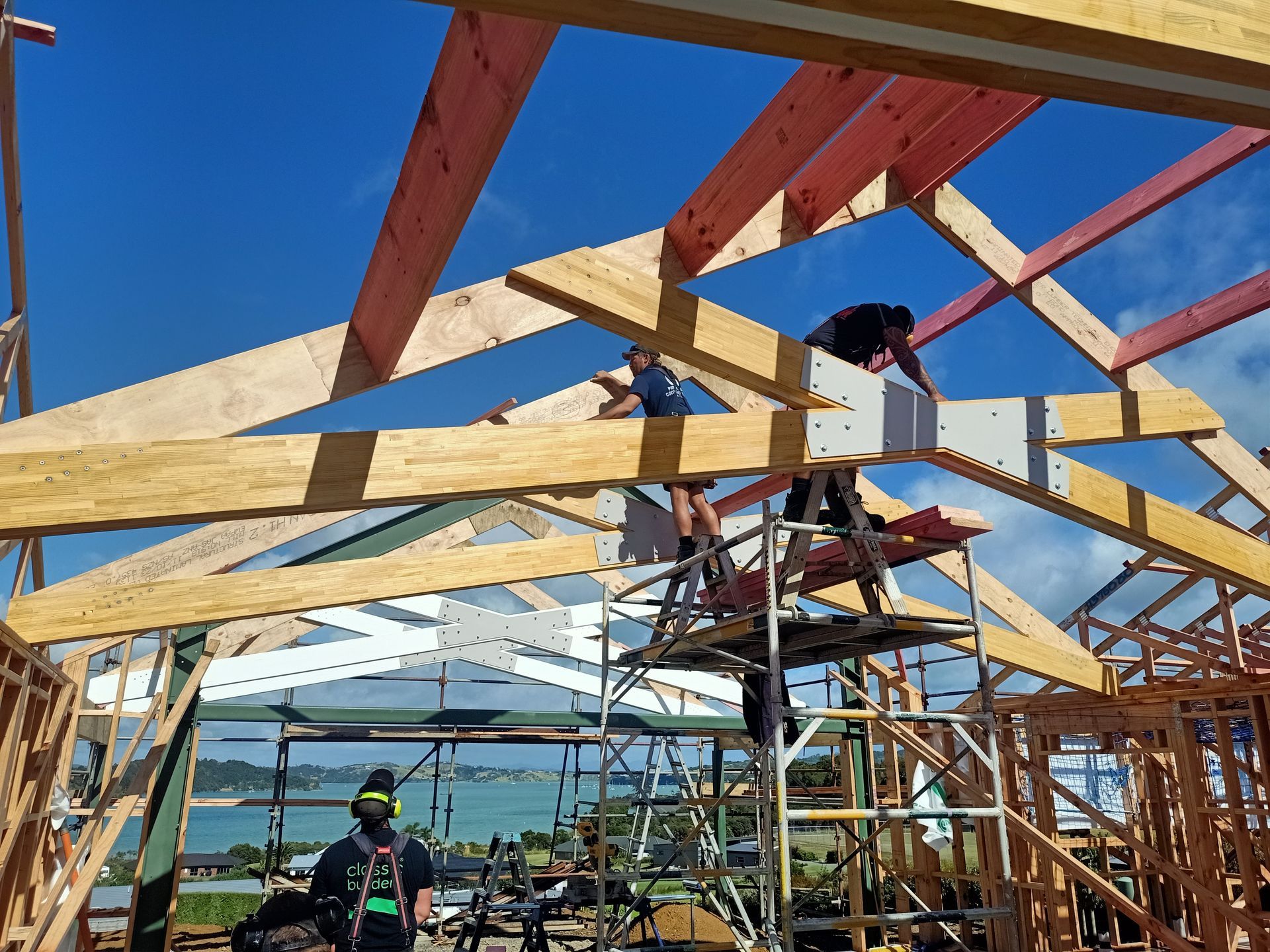 A group of people are working on a wooden structure.