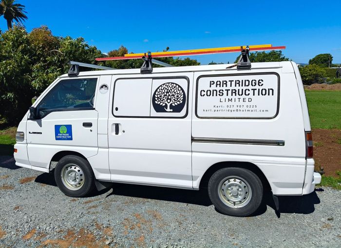 A white van with the word construction on the side