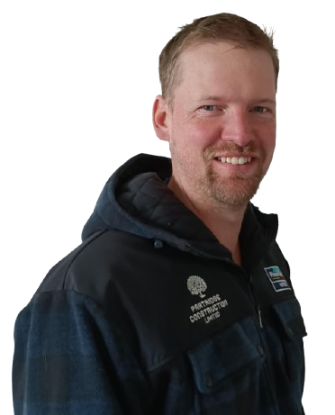 A man with a beard wearing a jacket that says ' precision construction ' on it