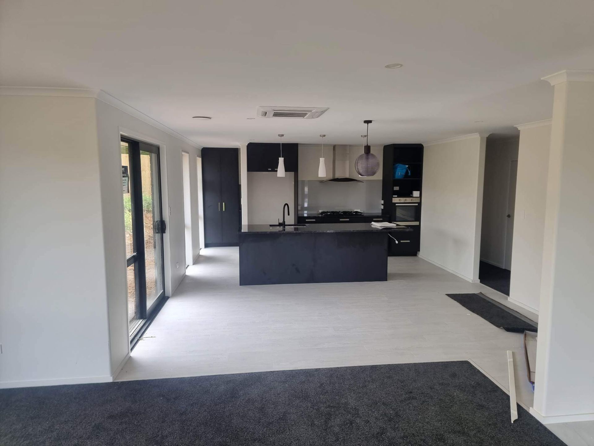 A kitchen with a black island in the middle of the room.