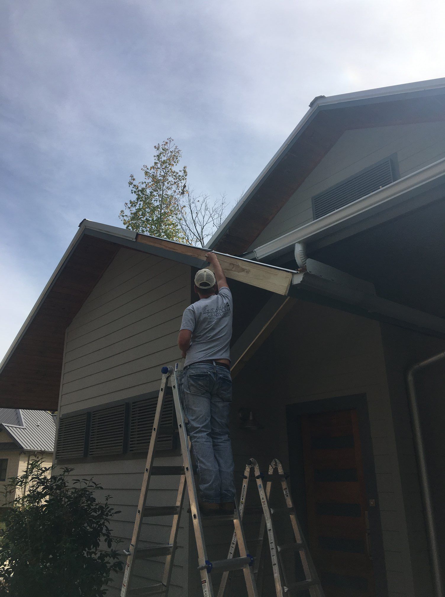 A man is wearing a tool belt and holding a toolbox.
