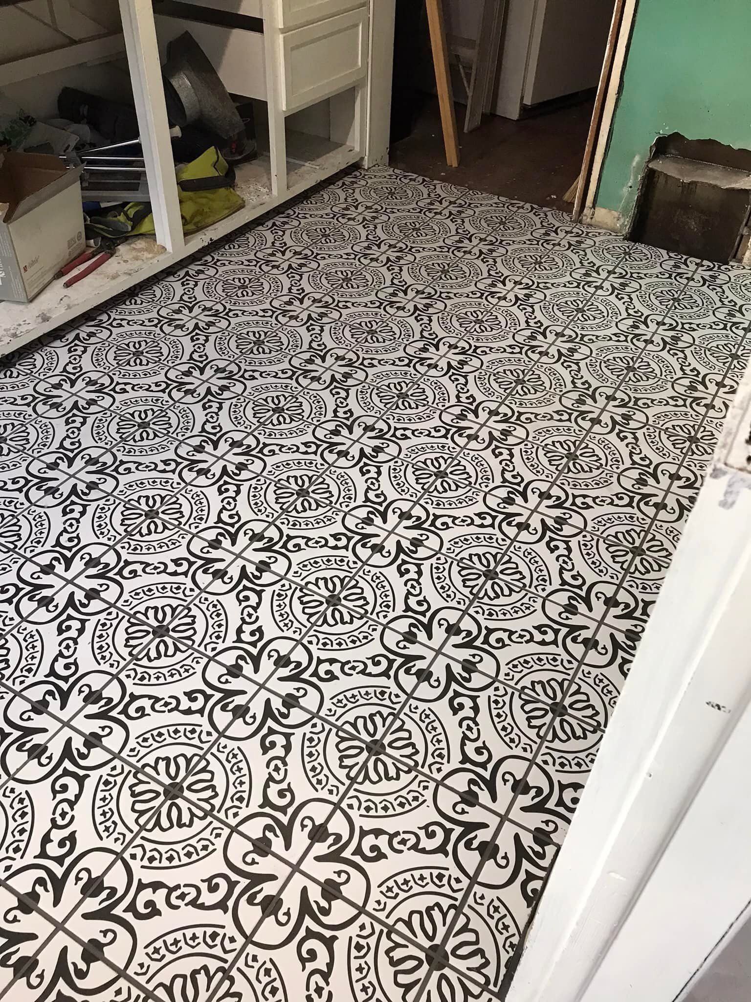 A black and white tile floor in a kitchen.