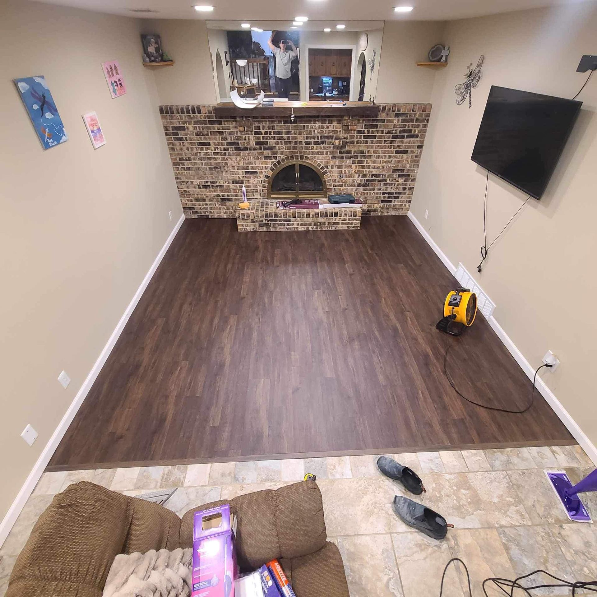 A living room with a fireplace and a flat screen tv