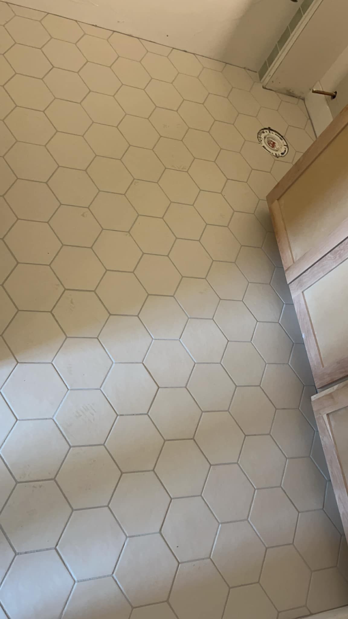 A bathroom floor with a honeycomb pattern and a sink.