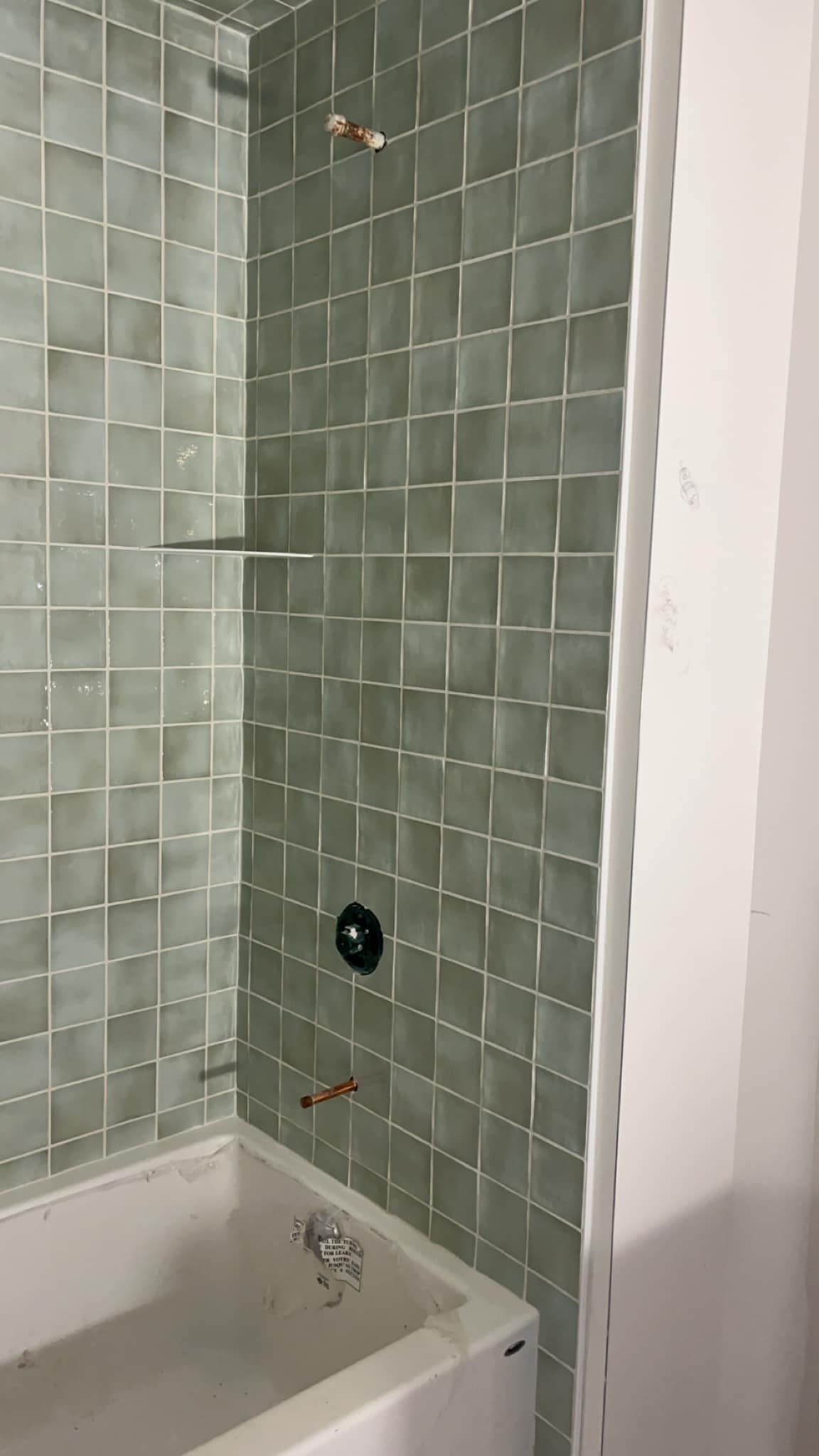 A bathroom with a bathtub and a shower.