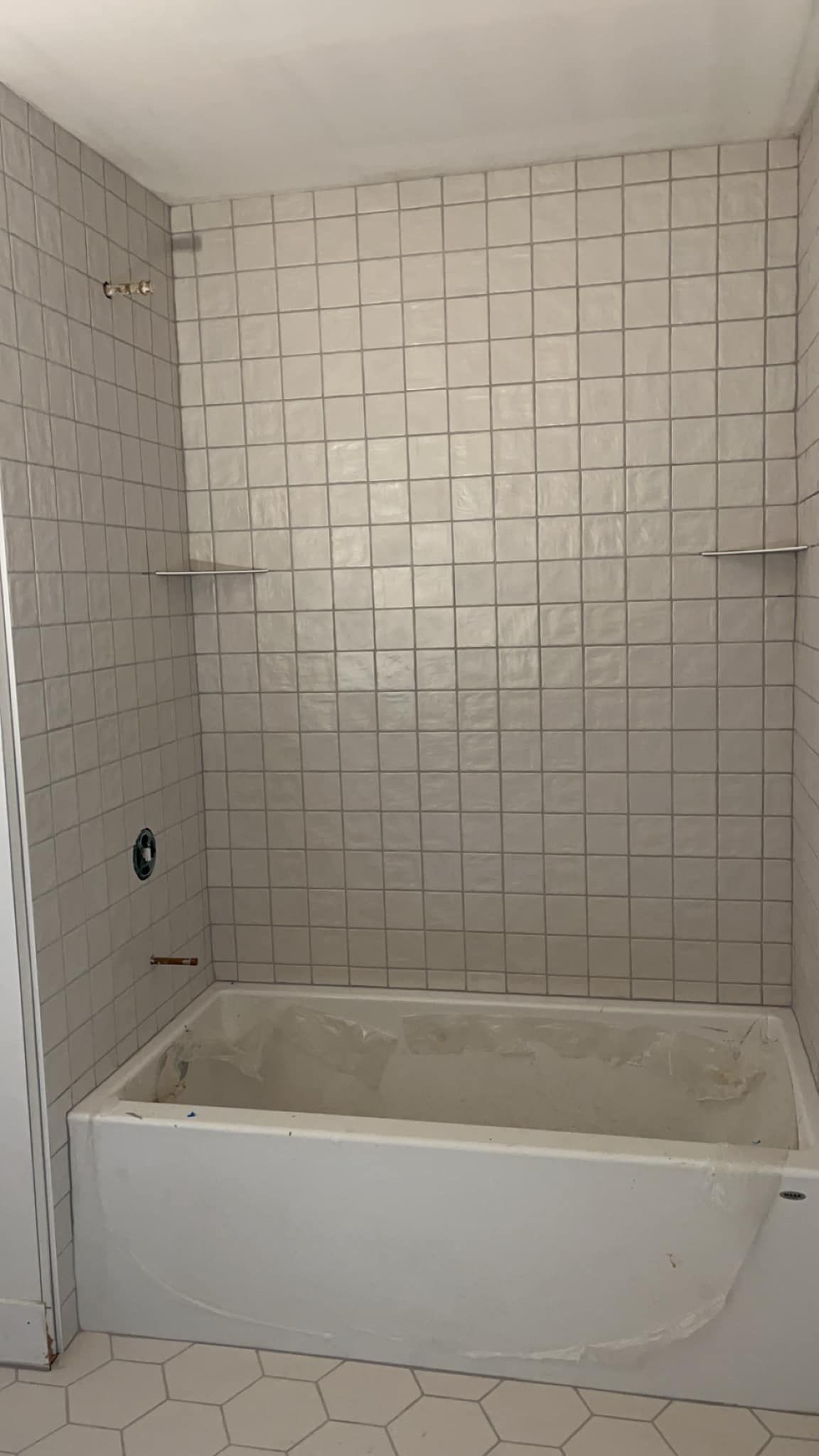 A bathroom with a bathtub and a shower.