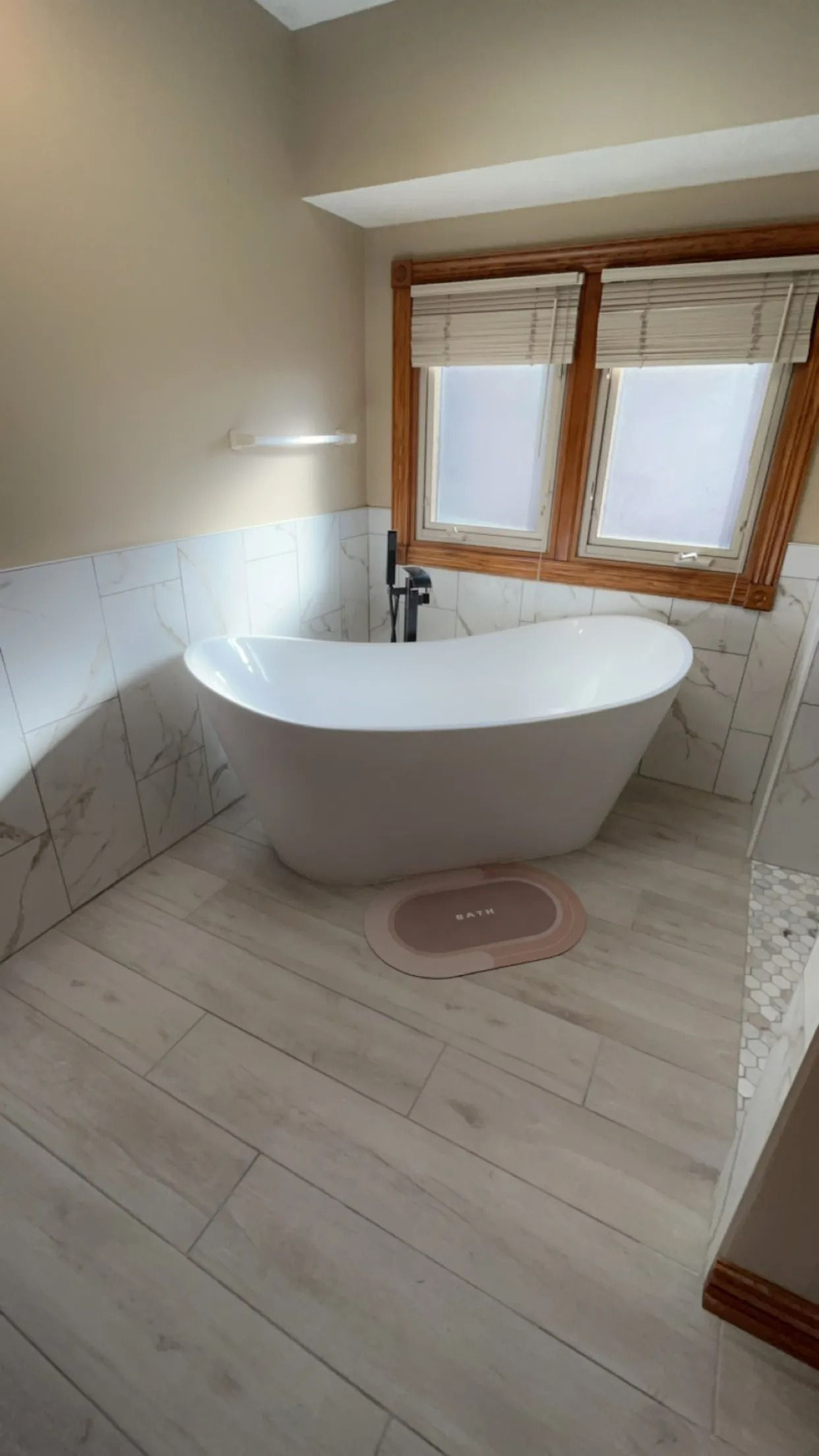 There is a bathtub in the middle of the bathroom.