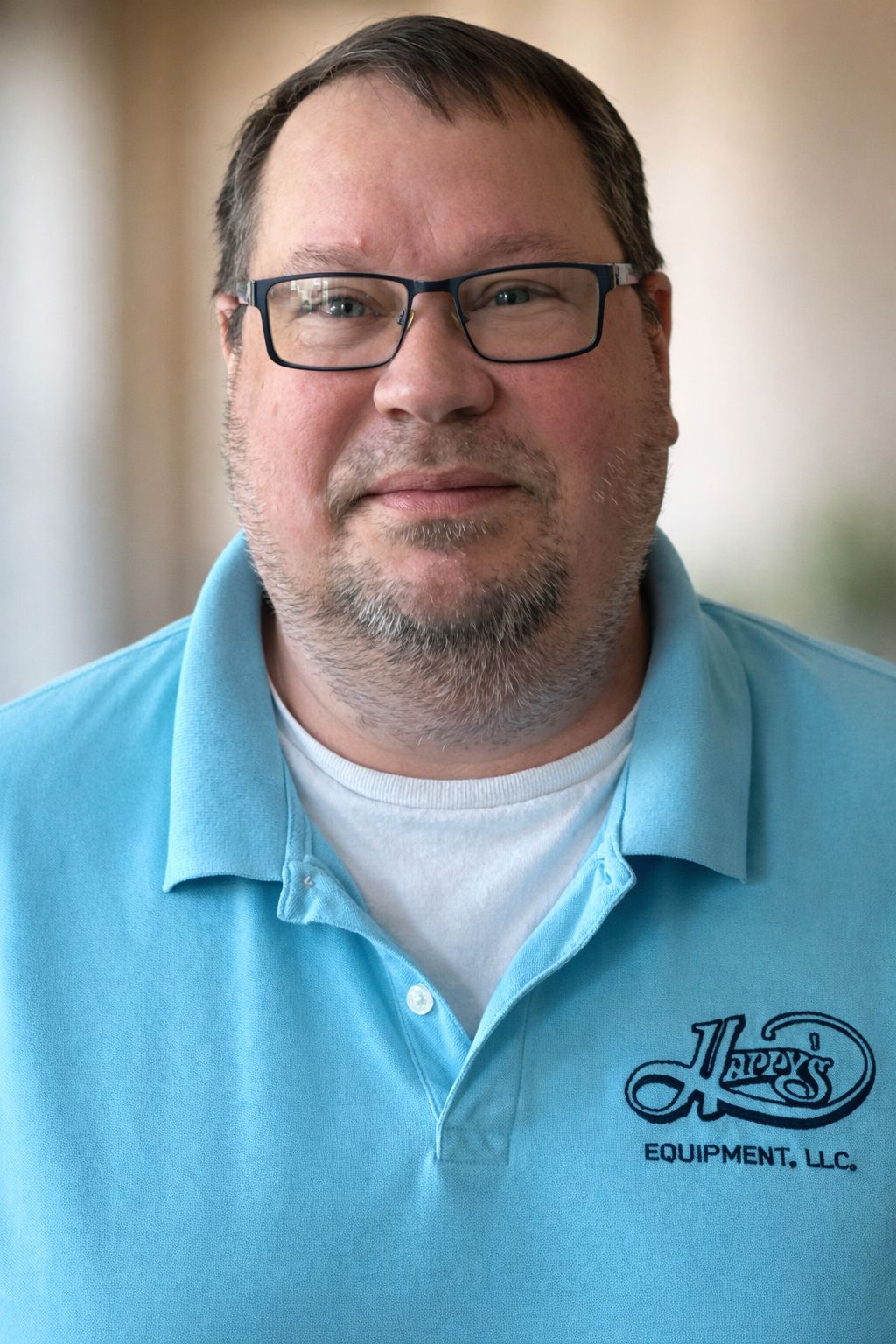 A person wearing a light blue polo shirt with a 