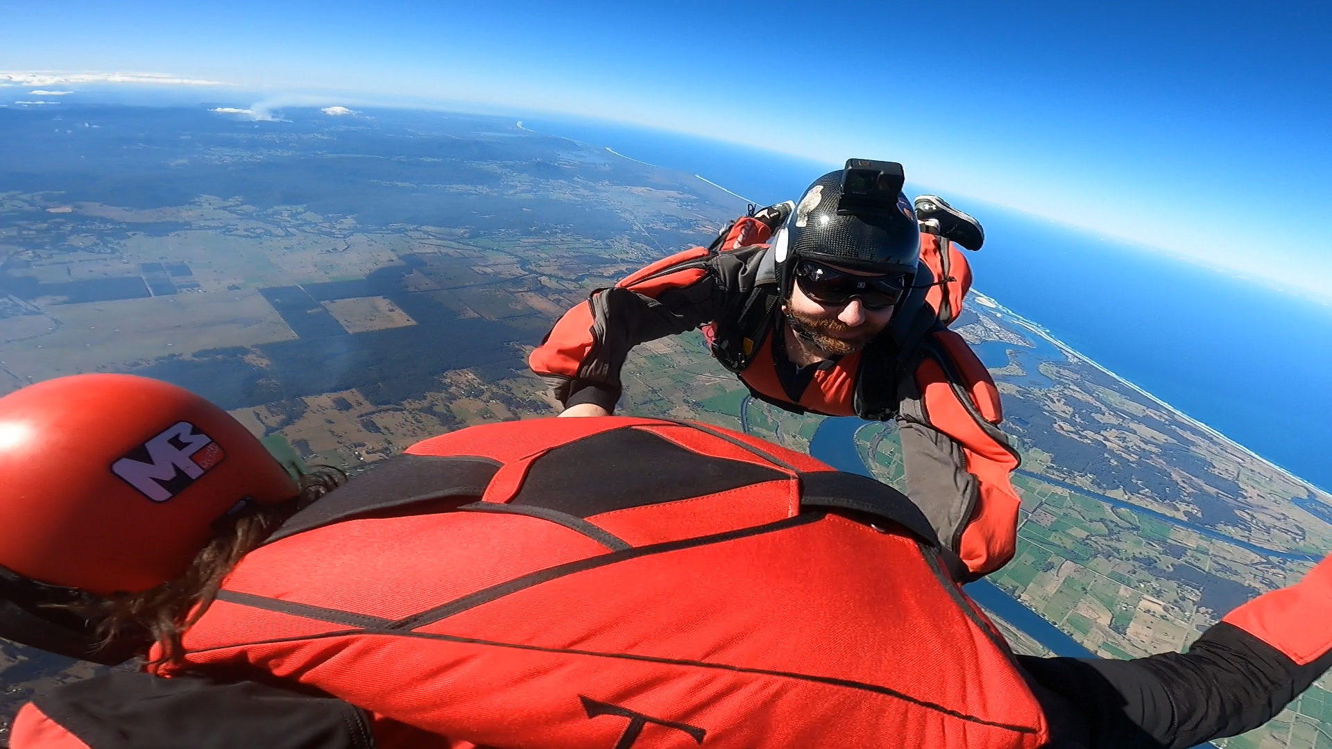 A man and a woman are flying through the air.