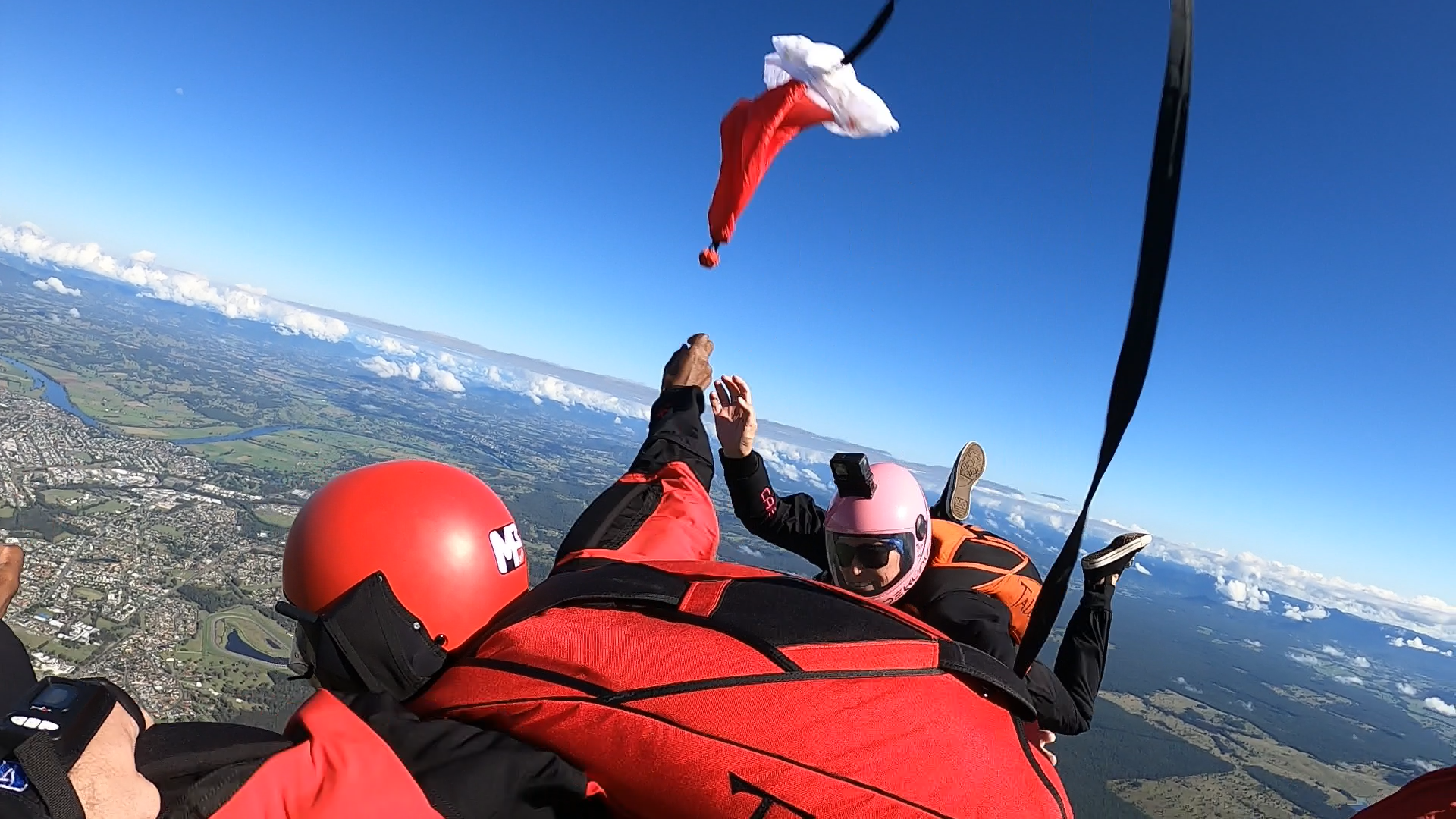 A person wearing a santa hat is flying through the air.