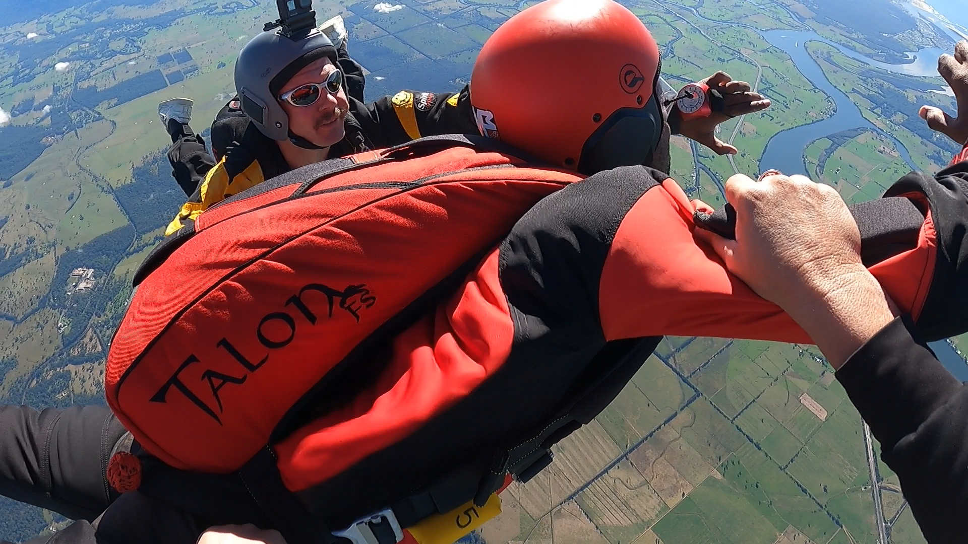 A person wearing a talons jacket is flying through the air