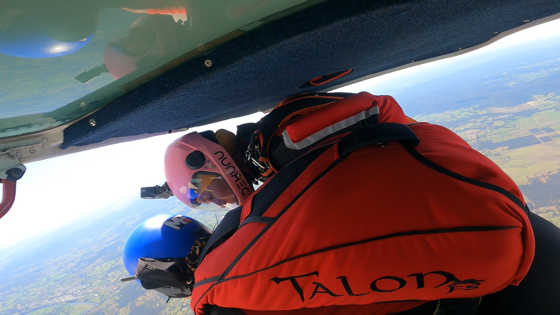 A person in a red talon bag is flying through the air