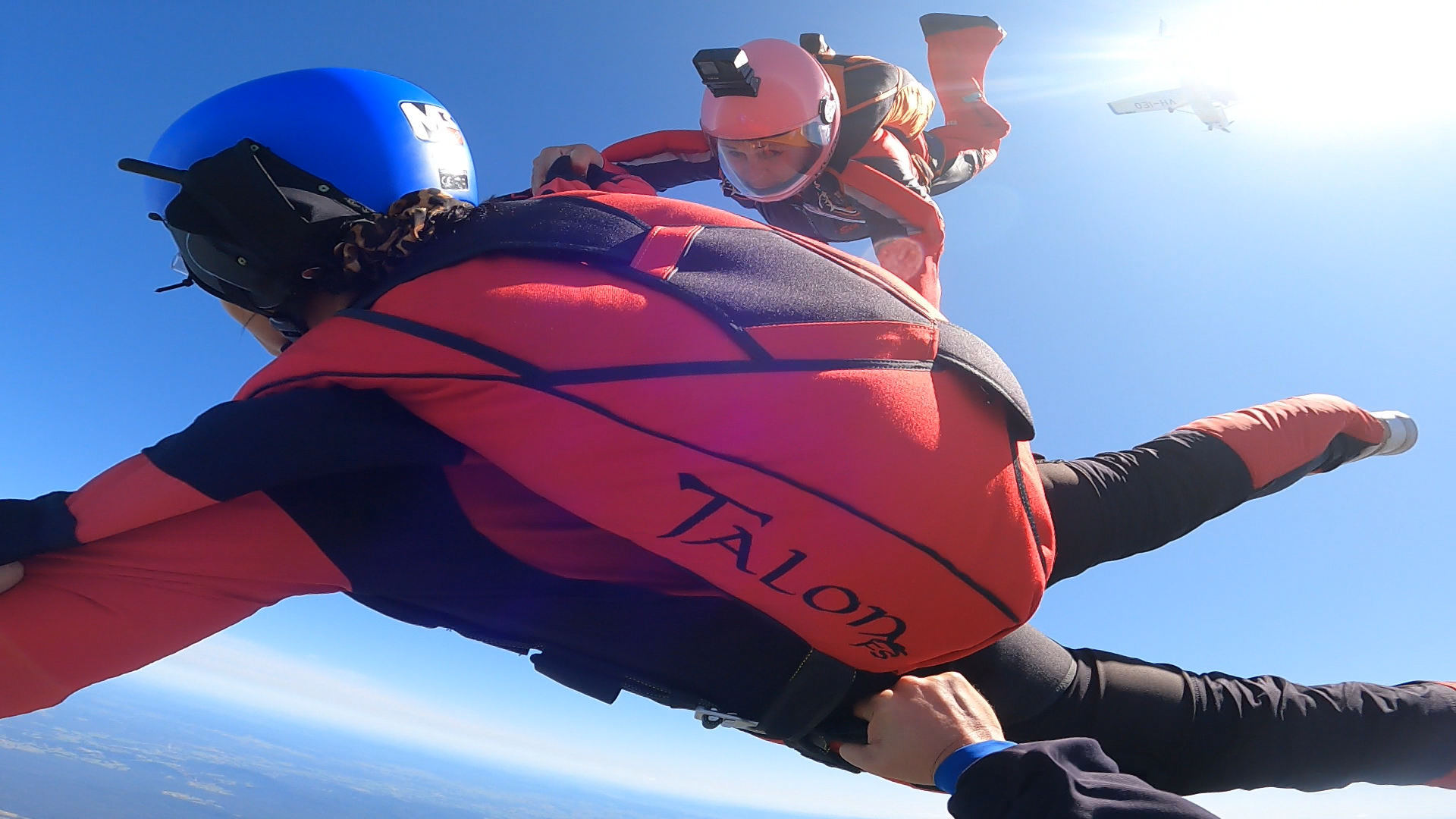 A person wearing a talon jacket is flying through the air