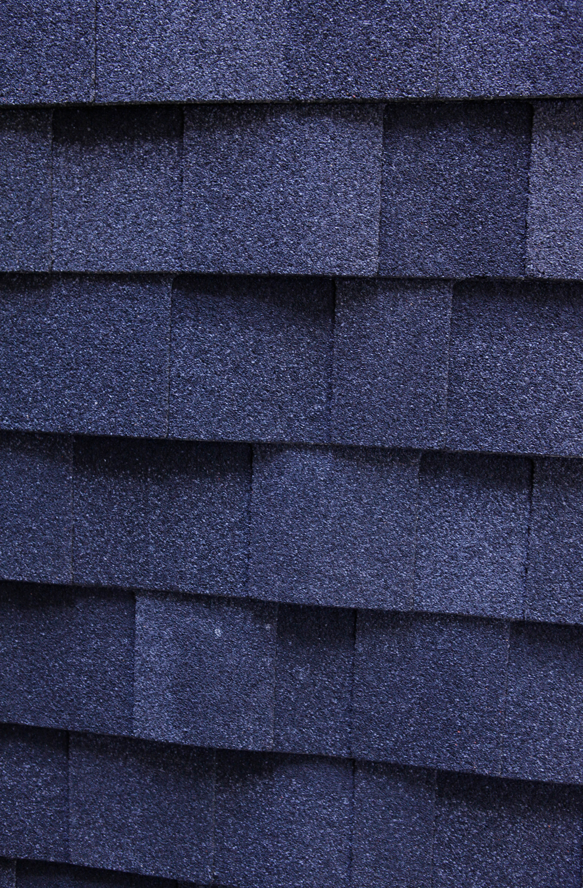 A close up of a row of blue shingles on a roof