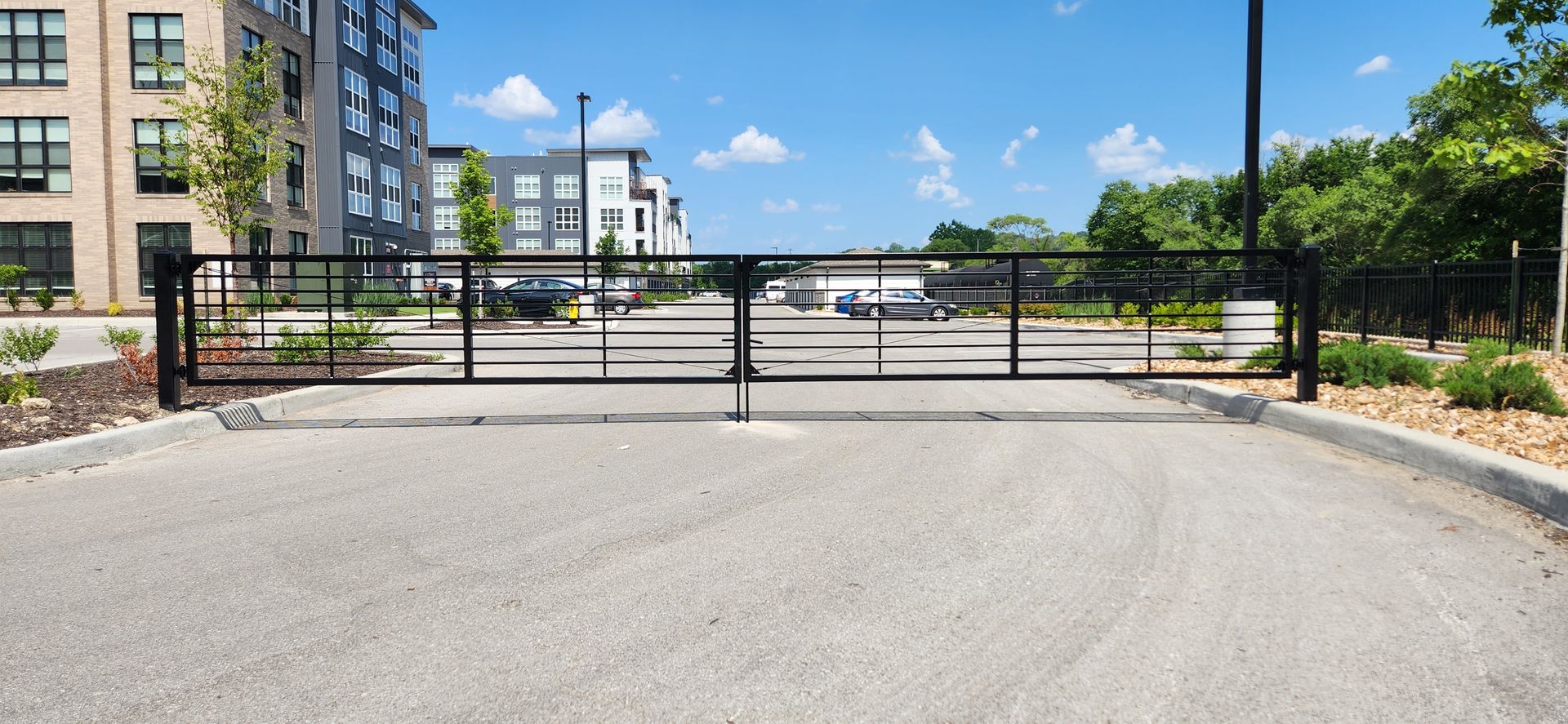 An empty parking lot with a gate in the middle of it.