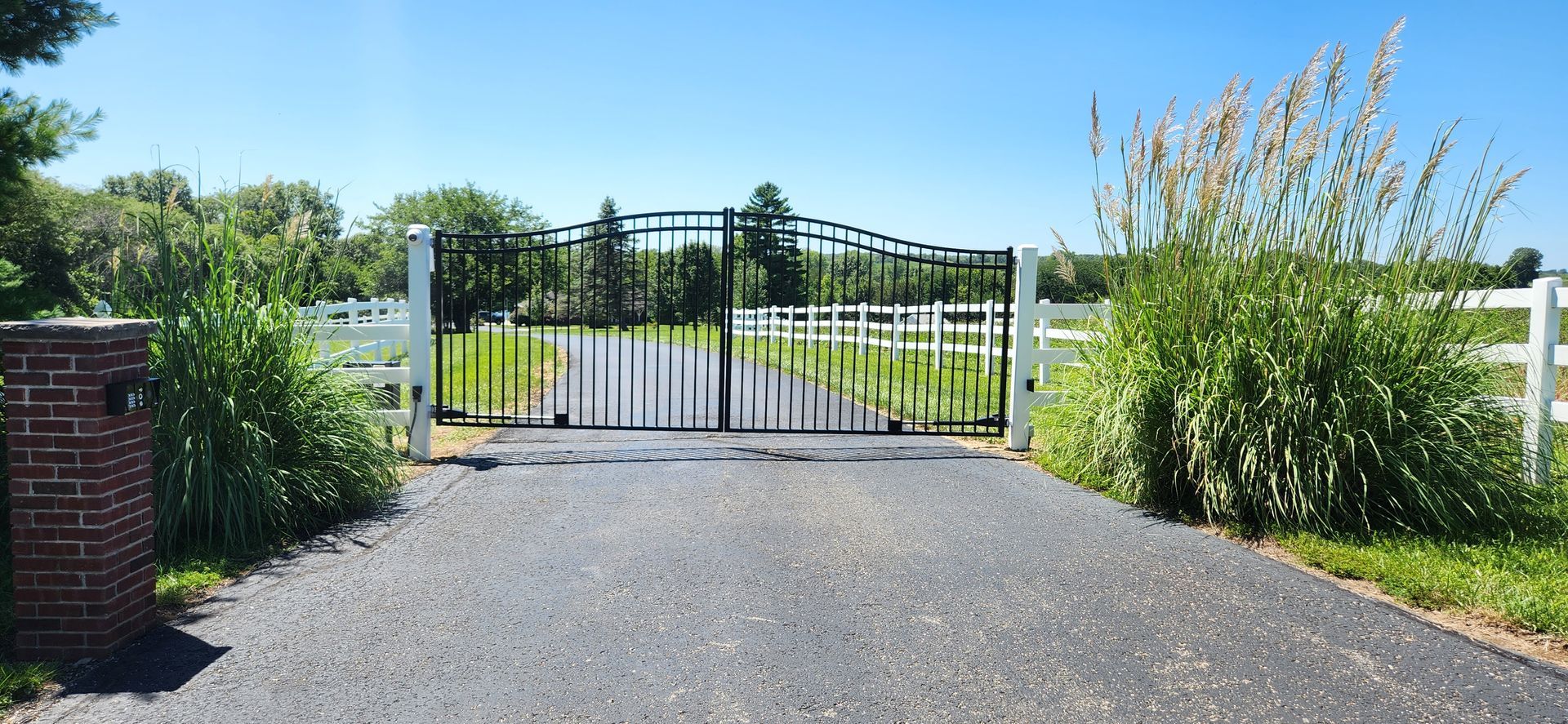 There is a gate on the side of the road.