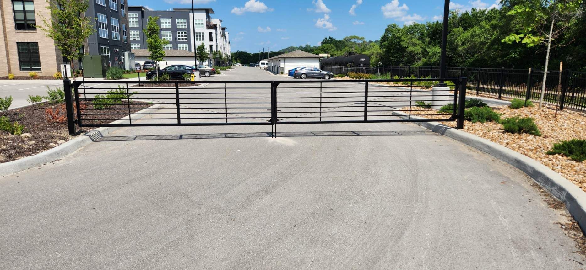 A gate is blocking the entrance to a parking lot.