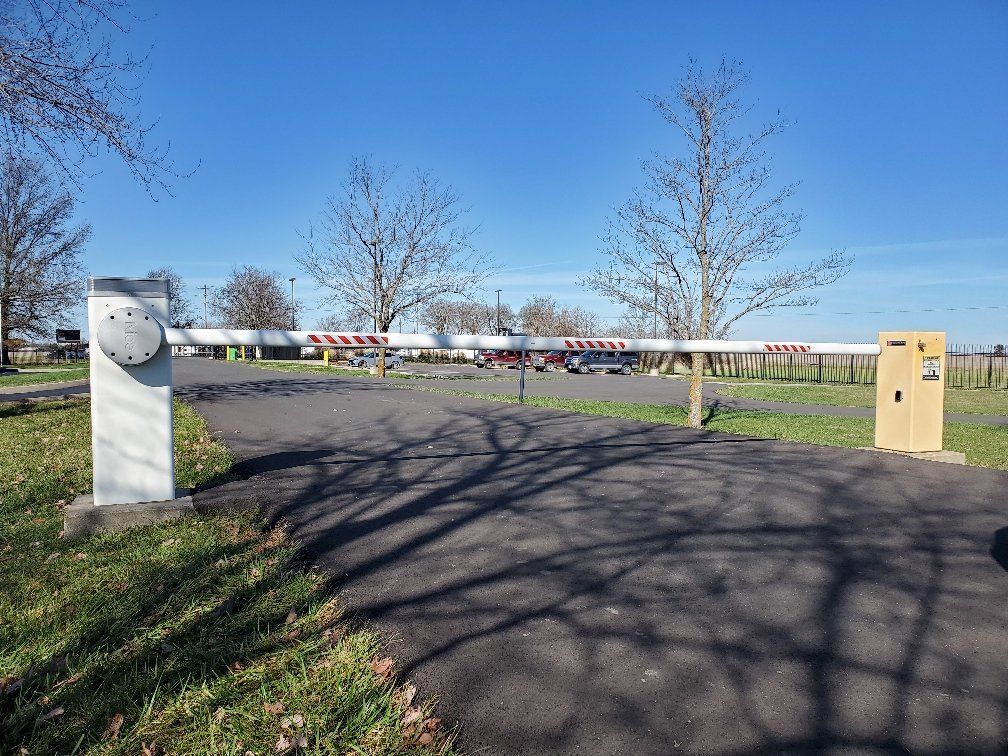A barrier is blocking the entrance to a parking lot.