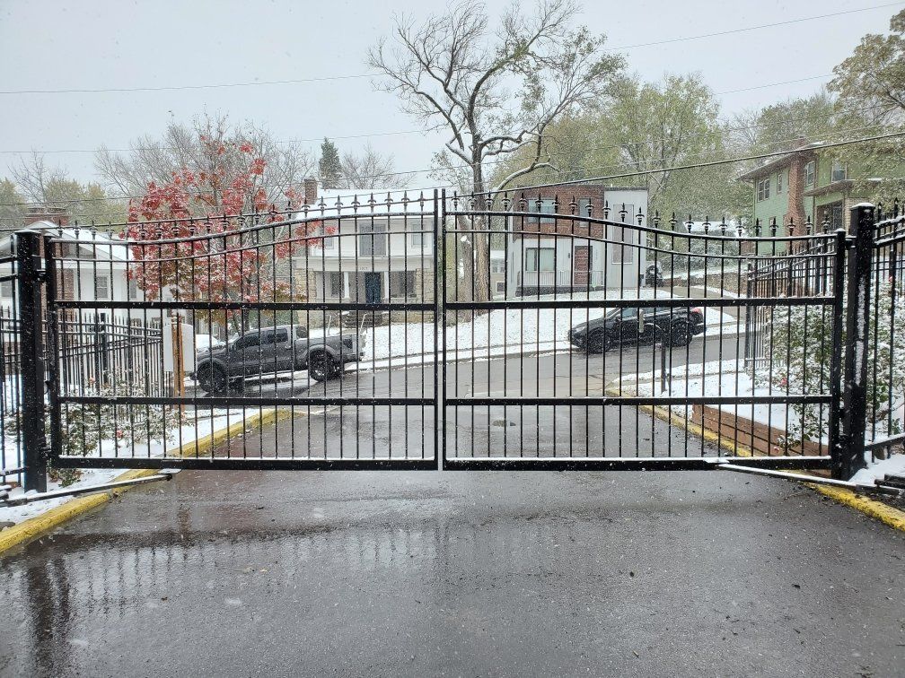 A car is driving through a gate on a snowy day.