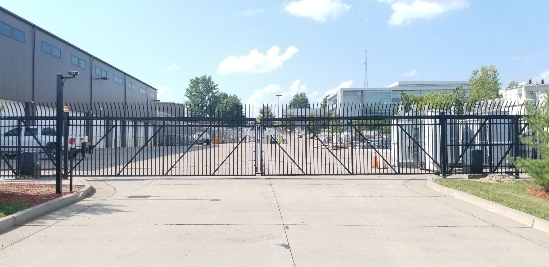 A black gate is closed in front of a building