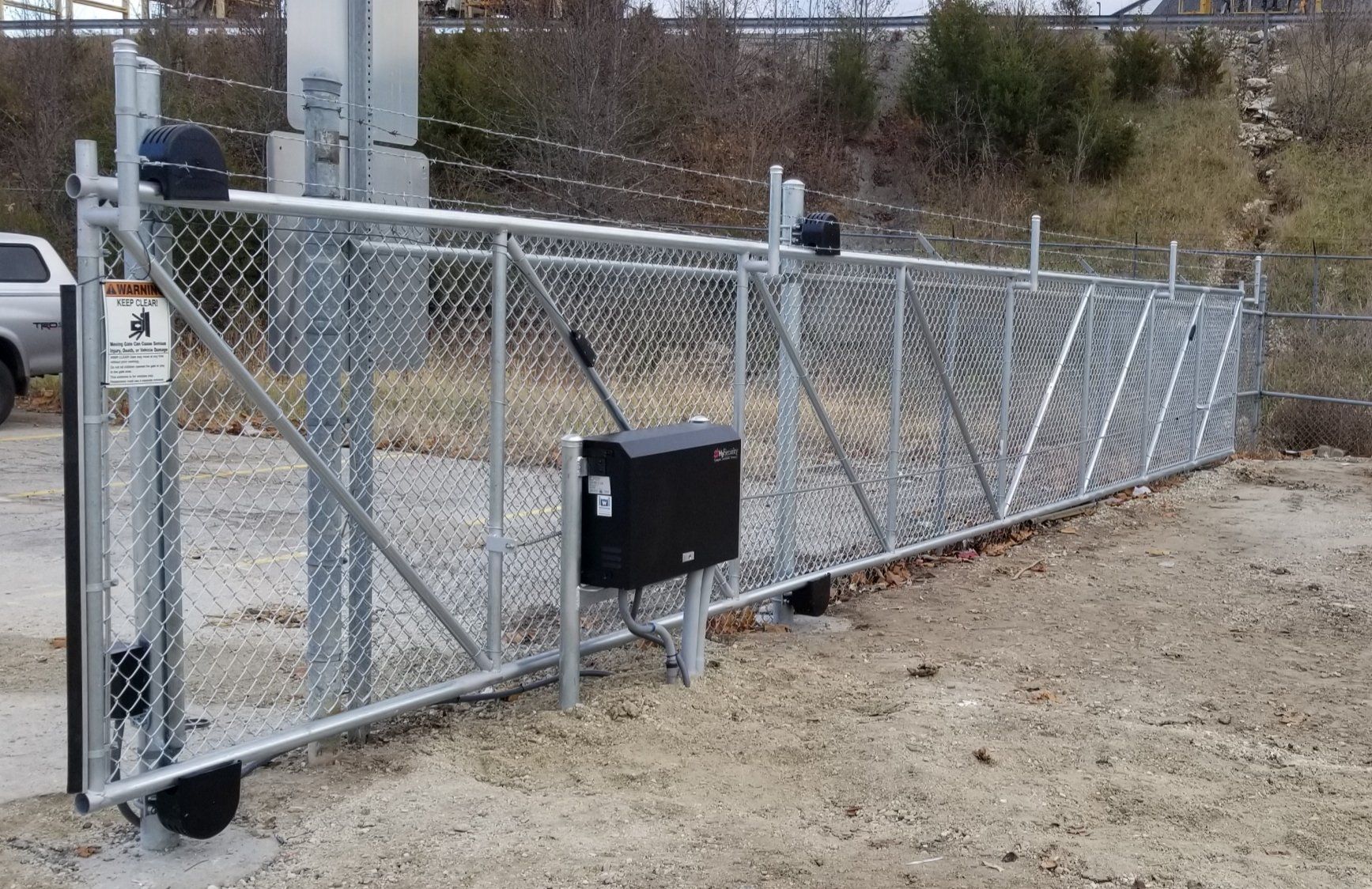 A sliding gate with a mailbox attached to it