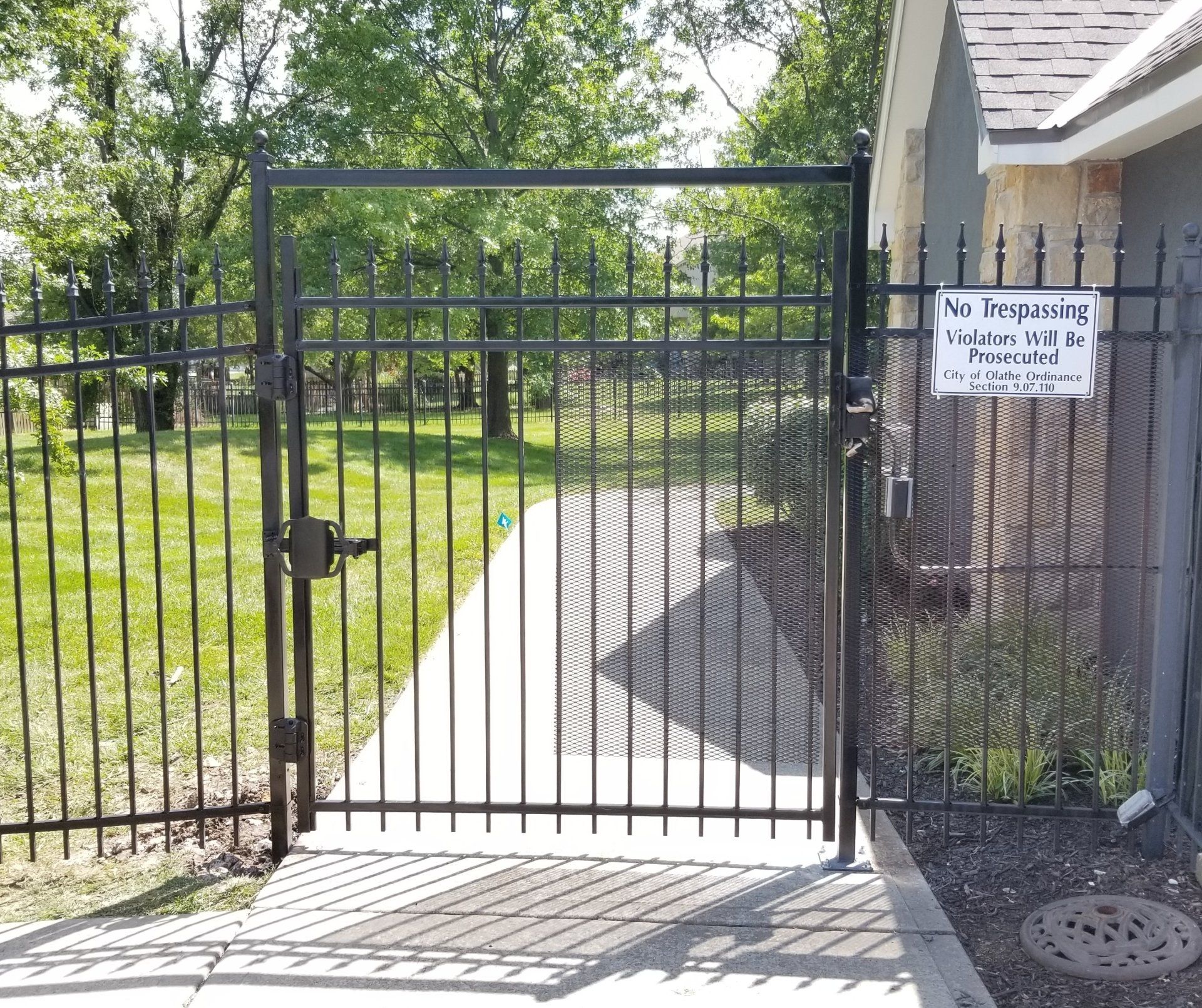 A fence with a sign on it that says no trespassing