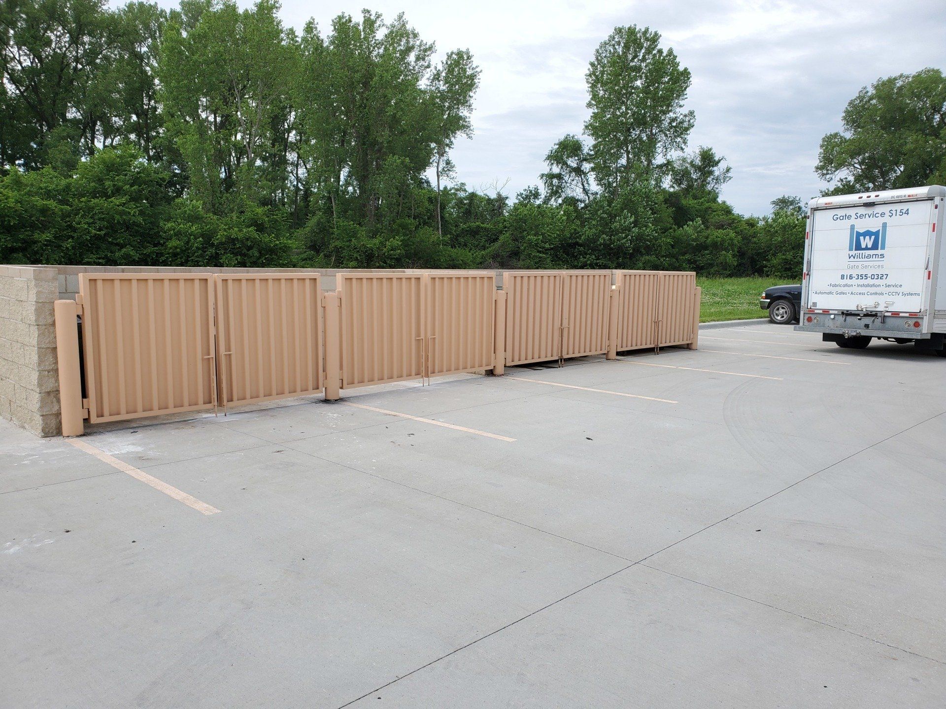 A white truck with the letter n on the back is parked in a parking lot